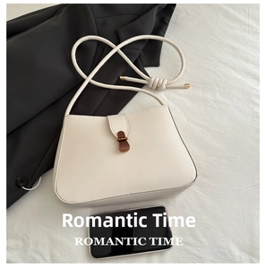 Top view of beige crossbody bag showing size comparison with a mobile phone