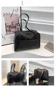 Close-up of black minimalist tote bag with smooth matte leather and functional front pocket