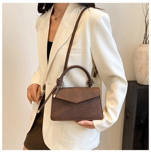 Deep brown matte vintage satchel with knotted leather handle and envelope flap closure