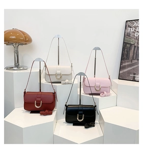 Detailed view of four small crossbody flap bags in red, beige, pink, and black colors