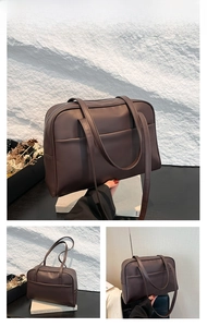 Detail view of large brown PU leather tote bag with shoulder strap and front pocket