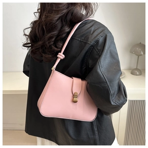 Detail of pink matte PU leather baguette bag with vintage bronze buckle and knot strap