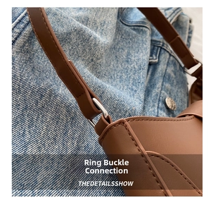 Detail of vintage brown leather bag with metal hardware connector and stitching
