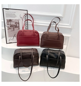 Close-up of four minimalist faux leather tote bags in burgundy, brown, coffee, and black