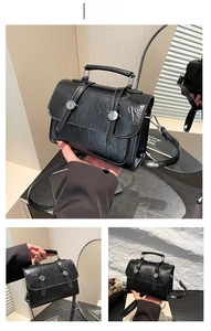 Detail of glossy black crinkled leather handbag with silver buckles and flap closure