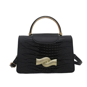 Black crocodile pattern handbag with golden circular handle and wave metal buckle closure