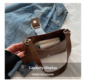 Internal capacity of the brown leather baguette bag showing main pocket and zipper
