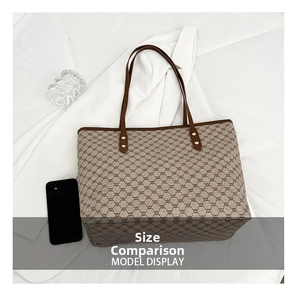 Overhead view showing large tote bag capacity with a phone for size comparison