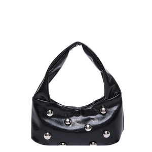Black glossy crescent shoulder bag with metallic stud accents and minimalist strap design