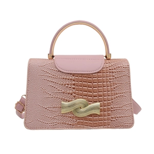 Pink stone pattern handbag with gold handle and wave clasp in a front view