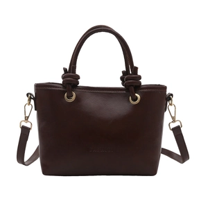 Dark brown leather bucket bag with FASHION embossment and knotted handle on white background