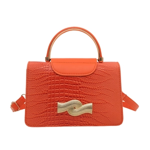 Orange faux leather handbag with lizard pattern and gold wavy metal clasp hardware