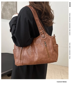 Detailed view of caramel brown tote bag featuring pebbled texture and side pockets