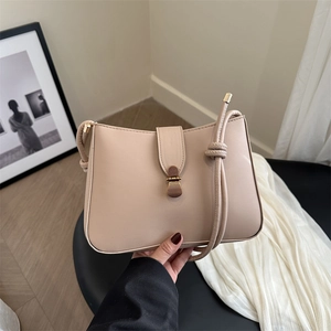 Beige French retro underarm bag with gold metal clasp and knotted strap detail