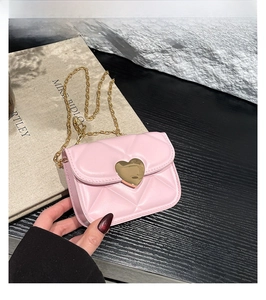 Détail du mini sac bandoulière rose matelassé avec fermoir coeur doré et bandoulière chaîne