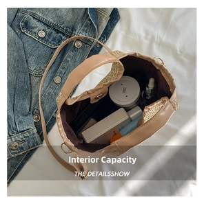 Top view of large straw tote bag showing spacious interior with cosmetic products