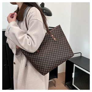 Side view of a large vintage plaid tote bag worn by a model for size and capacity detail