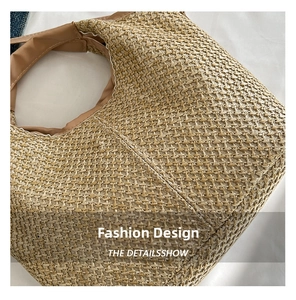 Close-up of natural woven texture and brown fabric trim on large straw tote bag