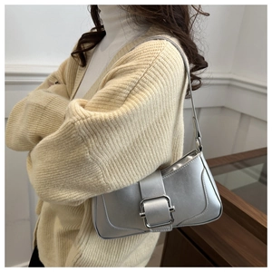 Silver underarm bag featuring a large metallic square buckle and a sleek rectangular silhouette