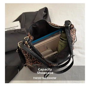 Interior view showing the large capacity of the leopard print tote bag with daily items