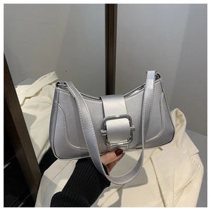 Detail of silver metallic underarm bag featuring a square metal buckle and leather strap