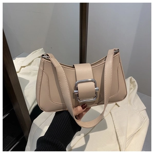 Detail view of beige baguette shoulder bag with large rectangular silver buckle accent
