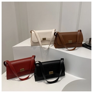 Detailed view of minimalist shoulder bags in white, brown, red, and black with gold buckles