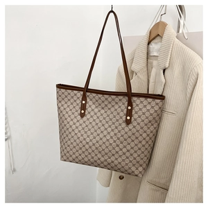 Detail of vintage monogram large tote bag with brown trim and long shoulder straps