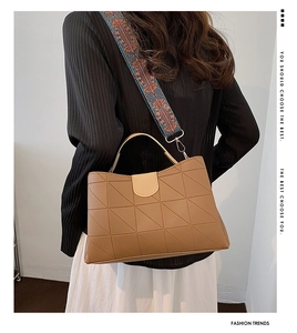Detail view of brown PU leather tote with geometric stitching and ethnic wide strap