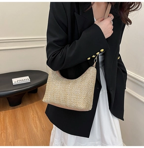 Detailed texture of the beige woven crescent bag with leather strap and gold hardware