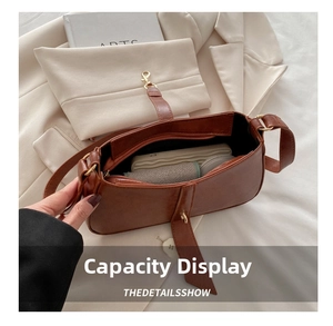 Internal view of brown leather shoulder bag showing storage space for daily essentials
