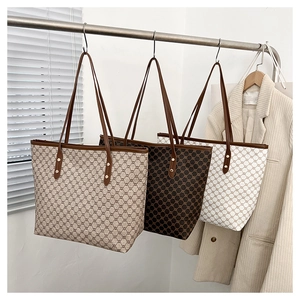 Detailed comparison of three retro tote bags with vintage patterns on a display stand