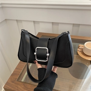 Minimalist black PU leather underarm bag with silver buckle in a chic setting