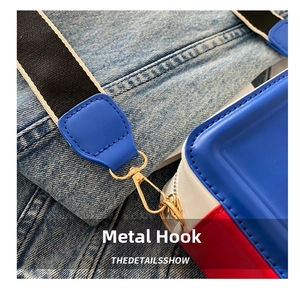Detail of high-quality gold hardware hook on a stylish color-block crossbody bag