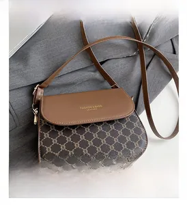 Vue détaillée du sac besace vintage avec motif monogramme marron et garniture dorée