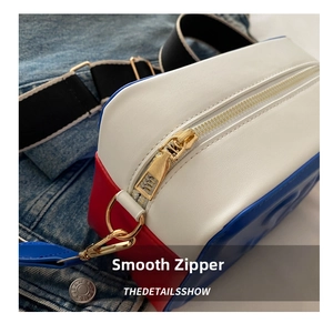 Detail of smooth gold zipper and embossed texture on the tricolor crossbody bag