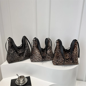Vintage leopard print hobo shoulder bags in three colors on a minimalist display stand
