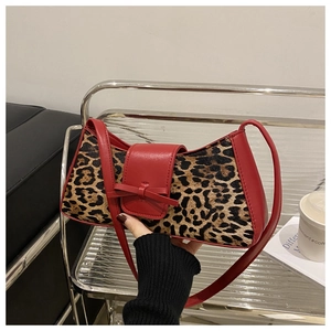 Detail der Schultertasche mit Leopardenmuster, rotem Leder und Schleifenschnalle