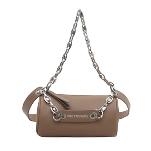 Modern brown cylinder crossbody bag with silver chain and wide leather strap in white background