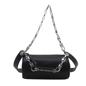 Modern black cylinder crossbody bag with chunky silver chain and wide leather strap