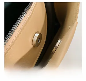 Detail view of strong magnetic clasp closure and interior zip pocket on PU tote bag