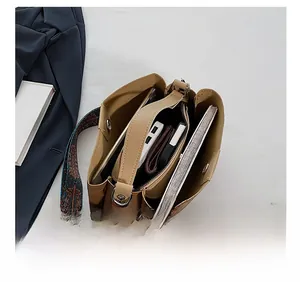 Interior view of large tan PU tote bag showing spacious compartments and ethnic strap