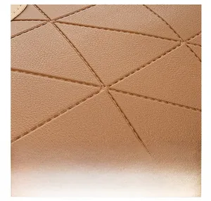 Close-up of brown PU leather bag with detailed geometric stitching and lychee texture