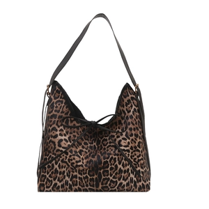 Leopard print tote bag with black bow detail and leather shoulder strap on white background