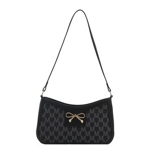 Black underarm bag with M-pattern jacquard and golden bow buckle on white background