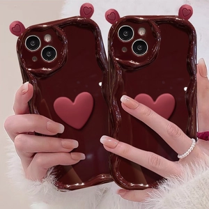 Detail of chocolate wavy iPhone case with 3D pink heart and cute heart-shaped charms