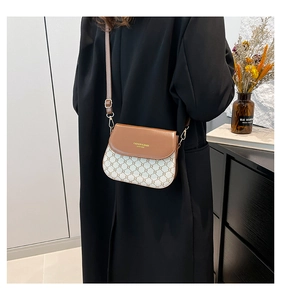 Détail du sac besace vintage avec rabat en cuir marron et toile à monogramme