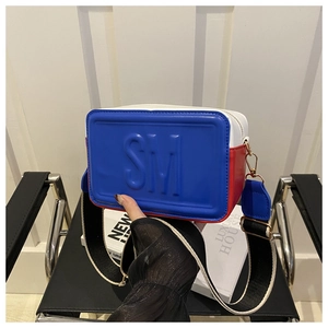 Detail view of the tricolor square crossbody bag featuring SM logo and wide strap