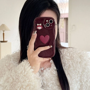 Detail view of wavy edge phone case with 3D pink heart and cute cartoon character