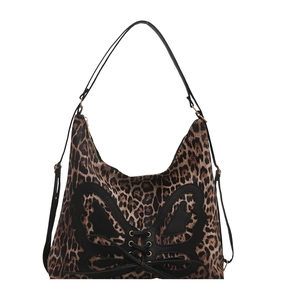 Leopard print canvas tote bag featuring black bow leather patch and metal eyelet details